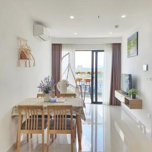 a dining room with a table and chairs with a view at Mô Tê Huế Homestay in Hue