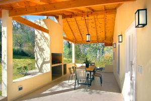 a patio with a table and chairs on it at La Faustina Casas de Campo in Villa General Belgrano