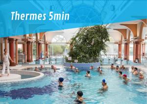 a group of people swimming in a swimming pool at Le Moulin du Lac, Terrasse, Neuf in Saint-Paul-lès-Dax