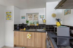 a kitchen with a sink and a microwave at Eastney Escape in Portsmouth
