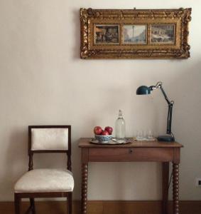 a desk with a chair and a lamp and a mirror at Just one room in Rome