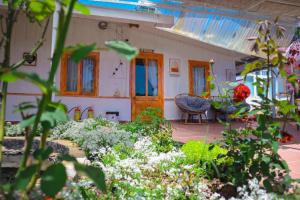 a garden with flowers in front of a house at Lưng Chừng House in Da Lat