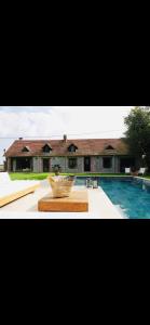 a large house with a swimming pool in front of it at 1h40 de paris - le perche - Normandie 