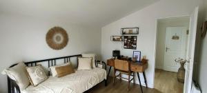 a bedroom with a bed and a desk and a table at La Cabane Bohème, Maison d'hôtes Bassin d'Arcachon in Gujan-Mestras