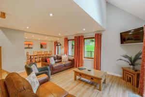 a living room with a couch and a table at Lord Galloway 36 with Hot Tub in Newton Stewart