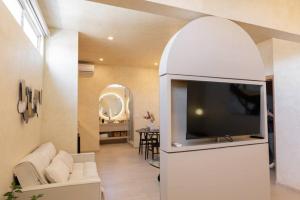 a living room with a flat screen tv in an archway at Presidential Studio with Gated Parking at Casas Sanblu in Ensenada