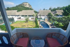 een uitzicht vanaf het balkon van een resort bij Neverland Hua Hin - Beach Retreat Home in Hua Hin