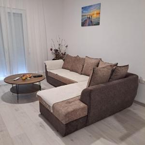 uma sala de estar com um sofá e uma mesa em Knežević apartman 