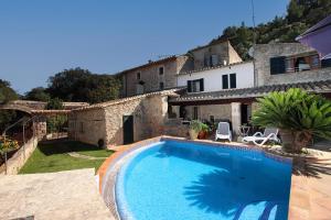 a large swimming pool in front of a house at Villa Camp Redo in Pollença