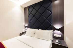 Postel nebo postele na pokoji v ubytování O Rooms Near Mumbai international Airport