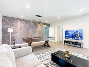 a living room with a pool table and a tv at Modern Friendly 3BR Habitat - WO - BUR in Burbank