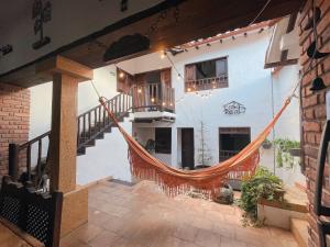 a room with a hammock in the middle of a house at Casa Real Barichara in Barichara