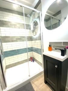 a bathroom with a shower and a sink and a showerspective at Garden annex in Welton