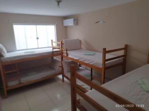 a room with two bunk beds and a window at HOSTEL APRISCO Do CAIS in Ilhéus