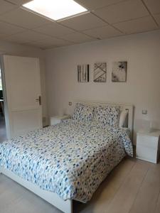 um quarto com uma cama com um edredão azul em Casa Celia em Valsequillo
