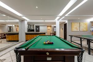 a pool table with balls on it in a room at Hotel Pires in Balneário Camboriú