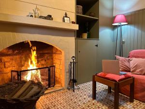 a living room with a fireplace with a laptop in it at Quinta José & Maria in Ferreira do Zêzere