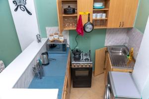 an overhead view of a small kitchen with a stove at Meraki home 3 in Kampala