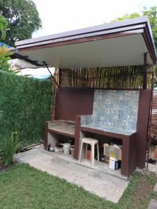 a shed with a bench in a yard at FAST Wifi 400 Mbps Tiny House in Bacolod City in Bacolod