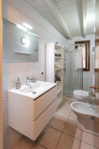 a white bathroom with a sink and a toilet at Sweet House a Veronetta - A pochi metri dal Centro in Verona