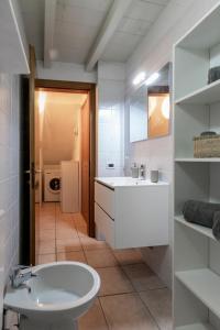 a bathroom with a sink and a toilet in a room at Sweet House a Veronetta - A pochi metri dal Centro in Verona