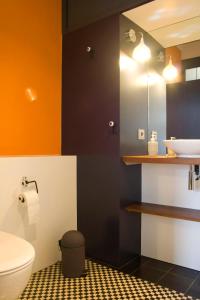 a bathroom with a white toilet and a sink at Bed & Breakfast Bells Oficis in Girona