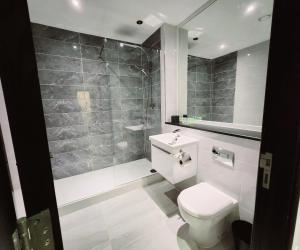 a bathroom with a white toilet and a sink at Remarkable 1Bed Apartment in Central Liverpool in Liverpool