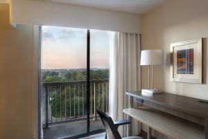 a hotel room with a desk and a large window at Holiday Inn Nashville Vanderbilt, an IHG Hotel in Nashville