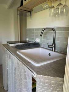 a kitchen sink with a faucet on a counter at La Cabane in Le Bar-sur-Loup