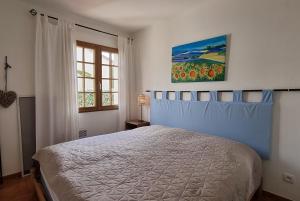a bedroom with a large bed and a window at Le Bariole, luxury villa with heated pool in Cesseras