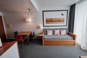 a hotel room with a bed and a table at Hotel Praia Marina by RIDAN Hotels in Praia da Vitória