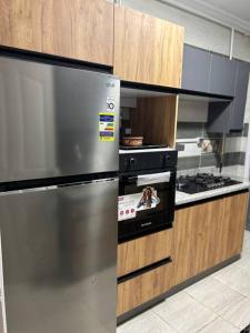 a kitchen with a stainless steel refrigerator and an oven at Gardenia city , Nasr city in Cairo