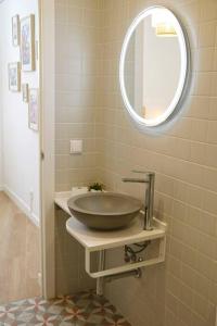 a bathroom with a bowl sink and a mirror at Casa da Sé in Silves