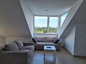 a living room with a couch and a table at BARREIROS RUA Vila in Barreiros