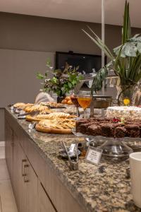 a buffet of food and drinks on a counter at Blue Tree Towers Millenium Porto Alegre in Porto Alegre