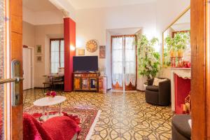 a living room with a couch and a tv at Hotel Albachiara in Viareggio