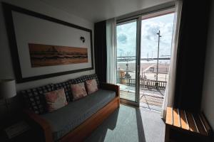 Hotel Praia Marina by RIDAN Hotels في برايا دي فيتوريا: غرفة معيشة مع أريكة ونافذة كبيرة