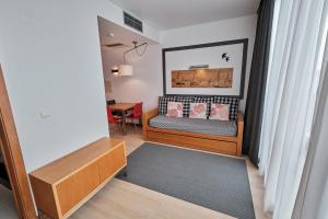 a small bedroom with a bed and a table at Hotel Praia Marina by RIDAN Hotels in Praia da Vitória
