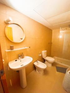 a bathroom with a sink and a toilet and a mirror at Playa Maria Apartment 43 (Puerta al Cielo) in La Playa Calera