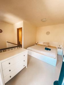 a bedroom with a bed and a dresser in it at Playa Maria Apartment 43 (Puerta al Cielo) in La Playa Calera