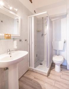 a bathroom with a shower and a sink and a toilet at Hotel Albachiara in Viareggio