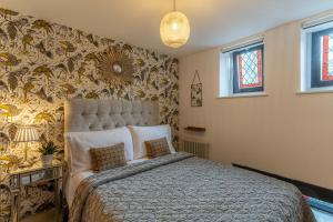 a bedroom with a large bed in a room at Luxury Chapel Apartment within City Walls in Chester