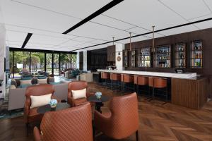 a lobby with a bar with chairs and tables at Four Points by Sheraton Shanghai Jiading in Shanghai