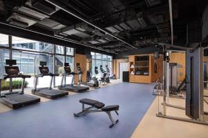 a gym with a lot of treadmills and machines at Four Points by Sheraton Shanghai Jiading in Shanghai