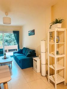 a living room with a blue couch and a table at Playa Maria Appartment 14 (Vista del Valle) in Valle Gran Rey