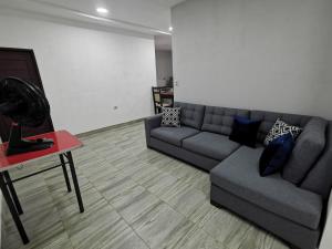 a living room with a couch and a table at El Depa de Saulo in Tarija