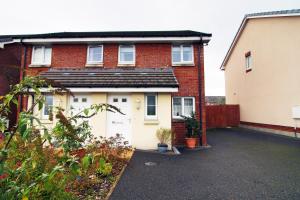 a house with a garage and a driveway at Beautiful Modern House with Free Parking in Swansea