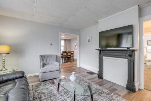 a living room with a fireplace and a tv at Central Auburn Apartment with Porch Pets Welcome! in Auburn