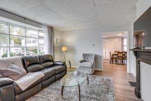 a living room with a couch and a table at Central Auburn Apartment with Porch Pets Welcome! in Auburn