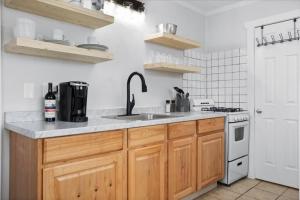 a kitchen with a sink and a stove at Unit 5: Sun drenched studio with tranquil vibes in Billings